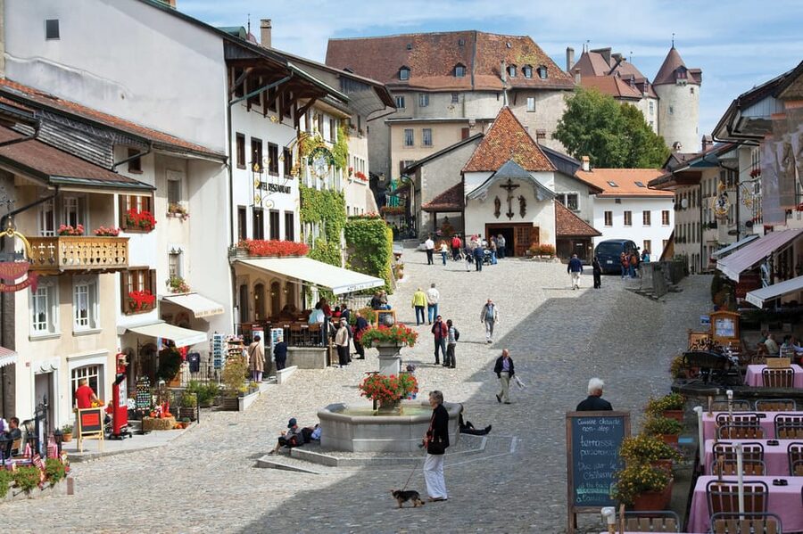 From Geneva: Gruyères Private Tour Cheese & Chocolat Factory - Walking through medieval Gruyères