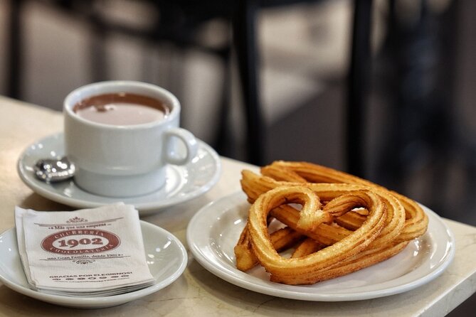 Madrid Bike Tour with Churros and Wine, Ham, and Cheese Upgrade - Gran Vía architecture and Madrid’s grand avenues