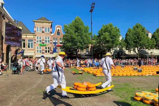 Small Group Alkmaar Cheese Market and City Tour <em>English</em> – Key reasons to book this Alkmaar tour’ /></p>
<ul>
<li><strong>Up-close cheese-market viewing:</strong> The small group may get a prime position or seating close to the trading area.</li>
<li><strong>A guide with local connections:</strong> Jennifer’s relationships with cheese carriers can add friendly conversations and a closer look at the tradition.</li>
<li><strong>More than a market visit:</strong> The route includes canals, cobbled lanes, the Grote Sint Laurenskerk, City Hall, the Waag, and the Molen van Piet.</li>
<li><strong>Useful historical context:</strong> You learn why Alkmaar is linked with the phrase Victory Begins at Alkmaar and how the market developed.</li>
<li><strong>A tasting stop built into the morning:</strong> You can sample several Dutch cheeses and buy extra to take home.</li>
<li><strong>A genuinely small group:</strong> The maximum is six people, with no guide umbrella or headset to follow.</li>
</ul>
<h2>Why the Alkmaar cheese market is worth your morning</h2>
<p>English</em> – Why the Alkmaar cheese market is worth your morning’ /></p>
<p><p>Alkmaar’s traditional cheese market is the heart of this experience. It is not simply a row of stalls selling cheese. The market preserves a centuries-old method of trading, with large wheels brought forward, weighed in the Waag, and carried by uniformed cheese carriers.</p>
</p>
<p><p>That movement is easy to watch but not always easy to understand on your own. A visitor standing at the edge may see people rushing about without knowing why a wheel is being moved, weighed, or carried in a particular way. Jennifer provides the missing story, so the activity becomes a tradition with rules rather than a colorful blur.</p>
</p>
<p><p>You spend about <strong>90 minutes at the cheese market</strong>, which is a useful amount of time. It gives you room to watch the action, hear the explanation, take photographs, and sample Dutch cheese without having to rush away after a quick look.</p>
</p>
<p><p>The tour’s small size is especially valuable here. With no more than six people, Jennifer can answer questions as they arise and adjust where the group stands. Past outings have included close viewing spots, special seating, and conversations with some of the cheese carriers. Those moments cannot be promised on every departure, but the small group and Jennifer’s local relationships make them more possible.</p>
</p>
<p><p>The market is also a place where timing matters. The tour starts at 9am outside Alkmaar train station on Friday, and the group heads toward the market together. If you arrive in Alkmaar independently, this early start places you in the center before the morning is gone.</p>
</p>
<div class="twil" style="margin: 20px 0; padding: 15px 0;"><p>More Market Visits in the Netherlands:</p><ul style="margin: 10px 0; padding-left: 0; list-style: none;"><li style="margin: 0 0 12px 0; padding: 0 0 12px 0; border-bottom: 1px solid #FDF5DC; line-height: 1.4;"><a href="https://fromagetrips.com/basel-farmers-market-cheese-chocolate-pastry-tour/">Basel Farmer’s Market, Cheese, Chocolate & Pastry Tour</a><br><span style="font-size: 0.82em; color: #555;"><span style="color: #F2B705;">★</span> 4.5 &nbsp;&middot;&nbsp; 171 reviews</span></li><li style="margin: 0; padding: 0; border-bottom: none; line-height: 1.4;"><a href="https://fromagetrips.com/basel-farmers-market-cheese-chocolate-pastry-tour-2/">Basel: Farmer’s Market, Cheese, Chocolate & Pastry Tour</a><br><span style="font-size: 0.82em; color: #555;"><span style="color: #F2B705;">★</span> 4.0 &nbsp;&middot;&nbsp; 18 reviews</span></li></ul></div><h2>Meeting Jennifer at Alkmaar train station</h2>
<p><img width="669" height="446" decoding="async" src=